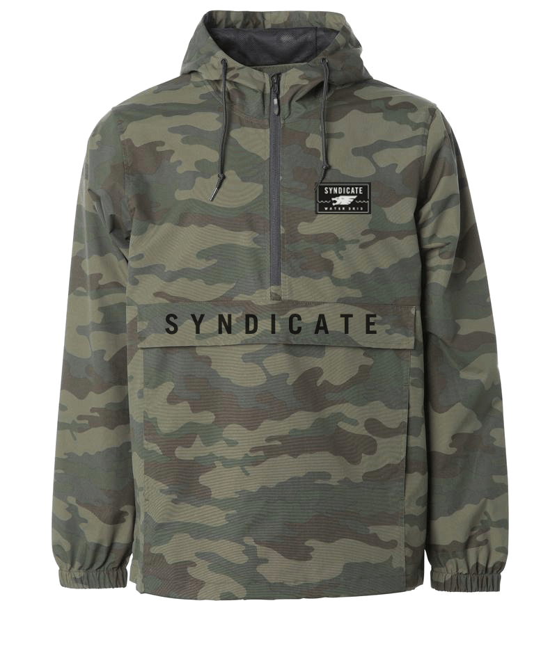 Front of the Syndicate Anorak in camo print, half-zip design, adjustable hood, and large front pocket with bold lettering.